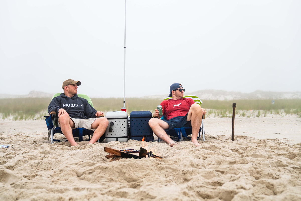 MULUS ROAMER backpacks beside a beach campfire